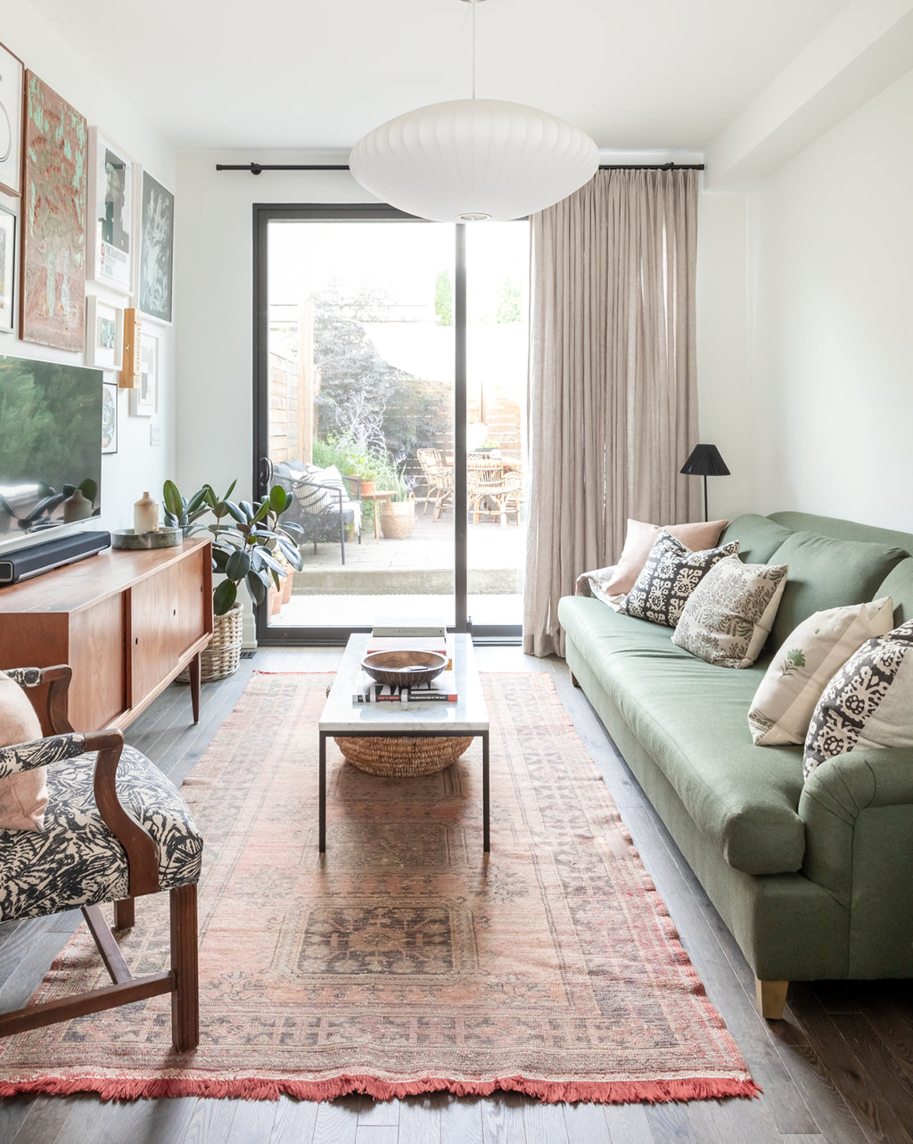 Hemme designed gallo kitchen leading to living room with custom floor length hemme curtains