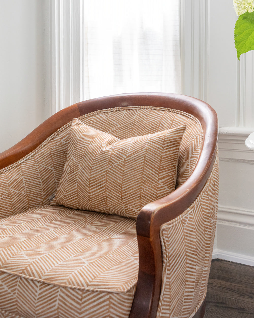 Custom arm chair in rust chevron Imogen Heath textile with matching rectangle throw pillow.