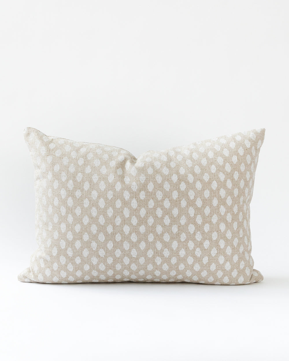 Rectangle ikat inspired dot pillow in a creamy white on a natural beige background