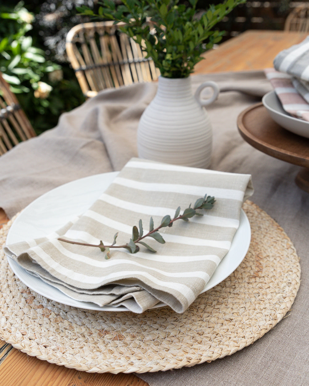 Marisol beige striped napkins sitting on table setting