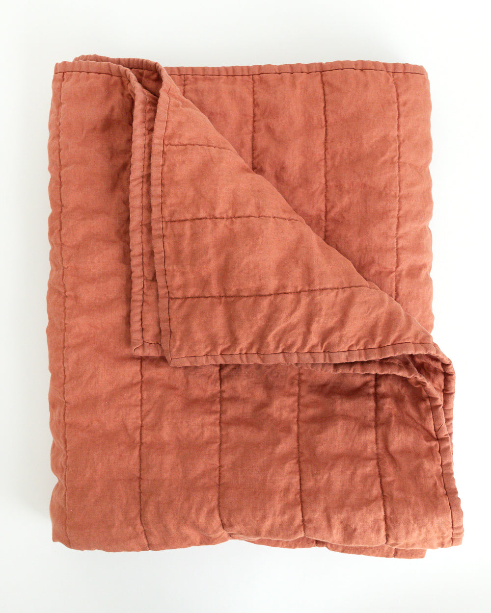 Folded warm rust colour handmade Linen Quilt