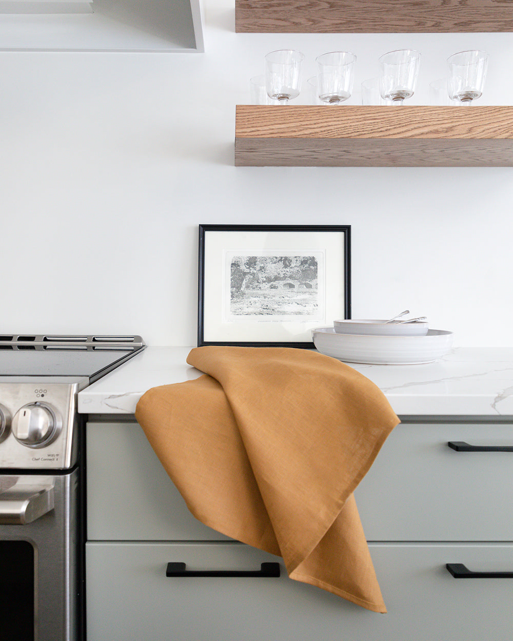  linen tea towel in brown earth-tone resting on counter