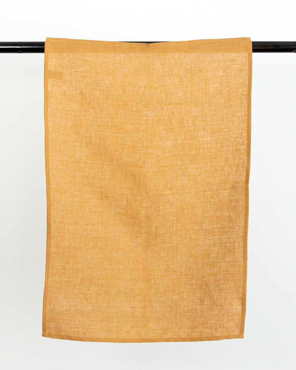linen tea towel in brown earth-tone hanging on black rod