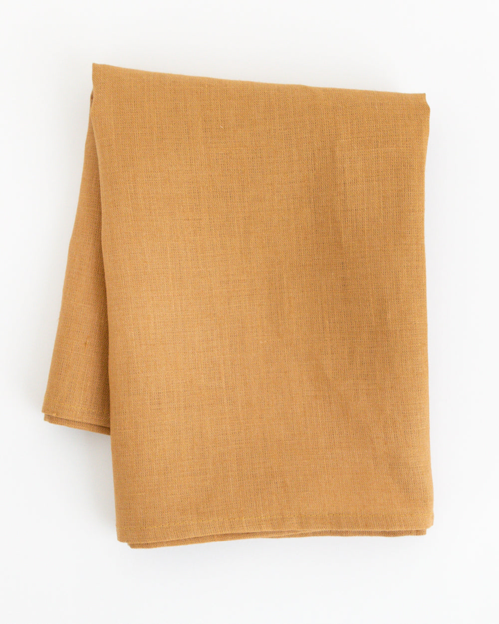 Folded linen tea towel in brown earth-tone