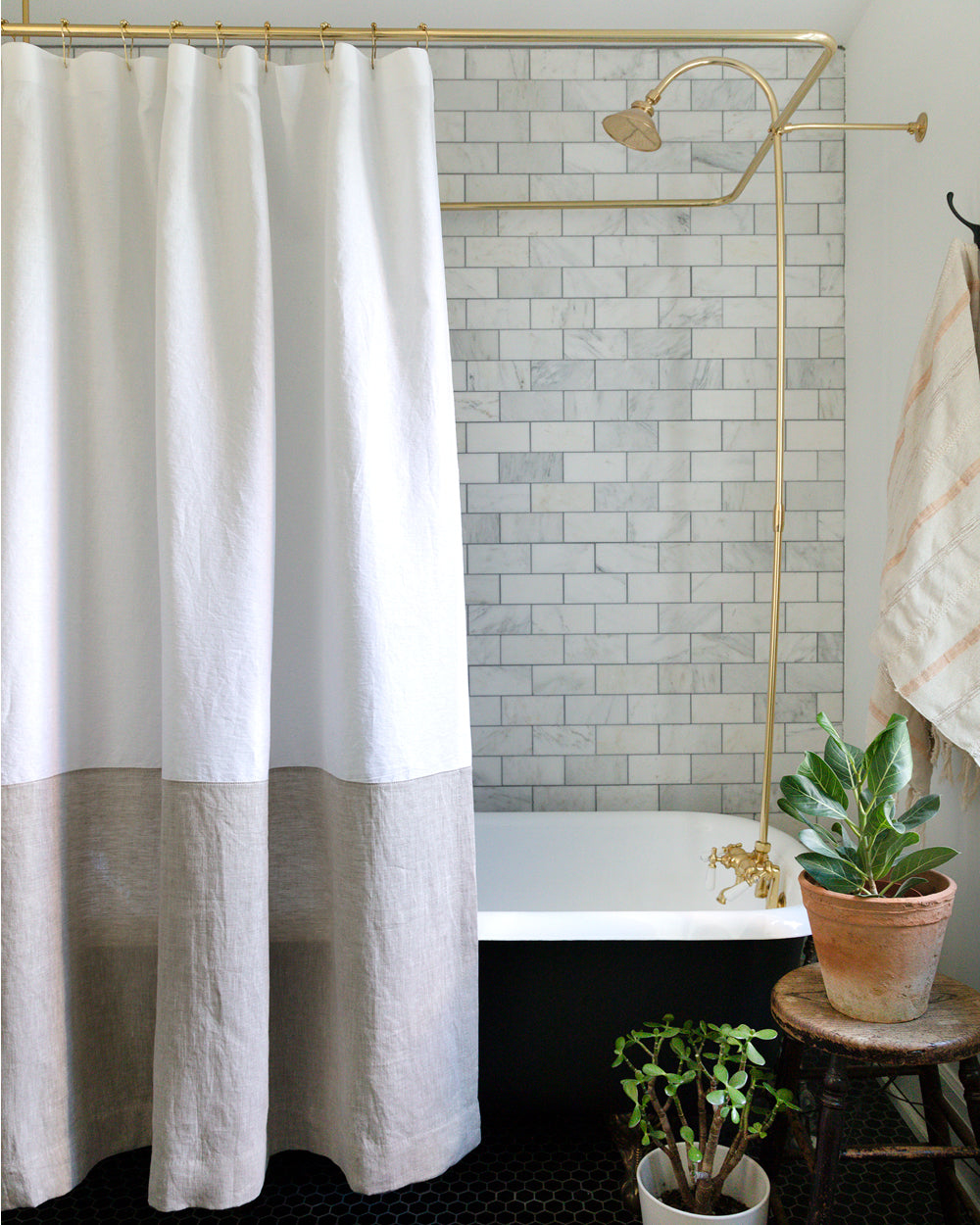 Spencer white and natural colour-blocked linen shower curtain hanging over bathtub