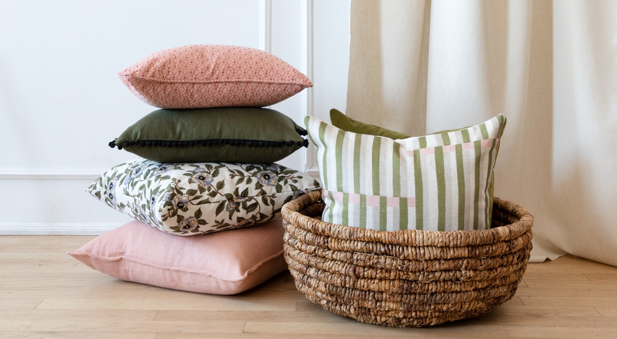 Pile of different coloured custom decorative pillows. 