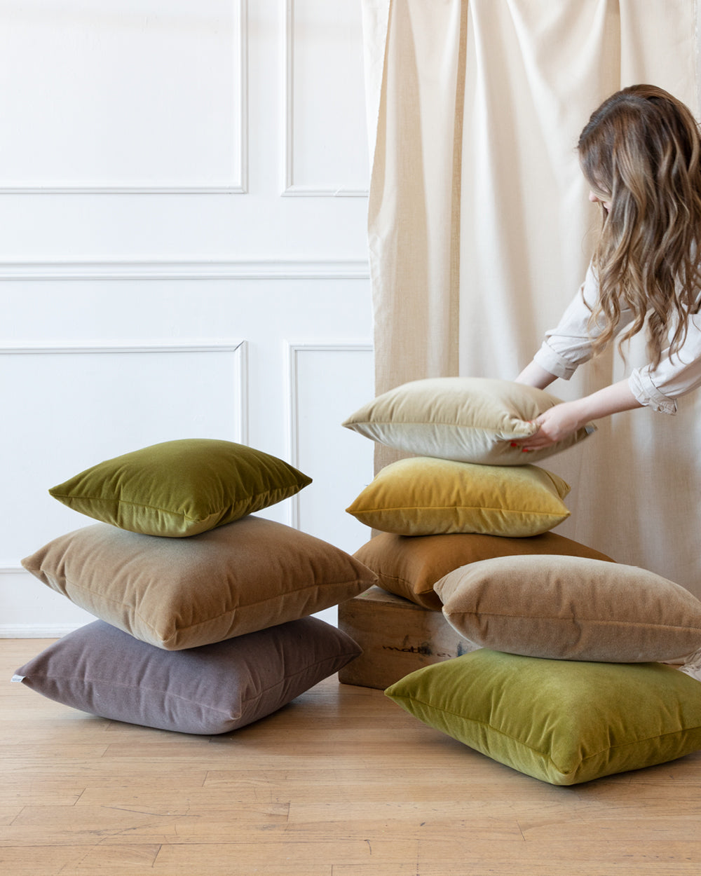 multiple piles of different colour mohair pillows