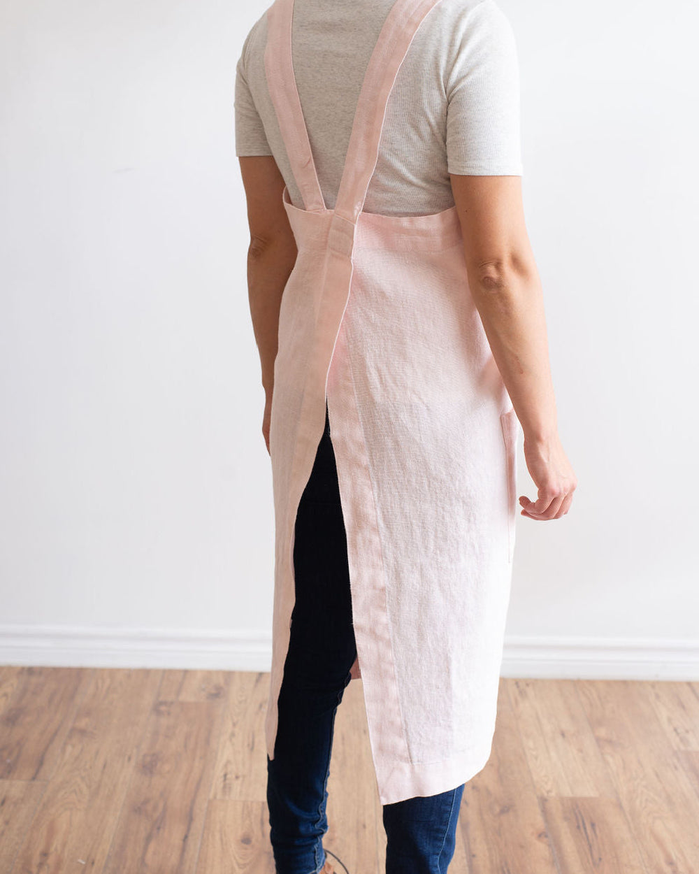 Back of person wearing Annie Linen Smock Apron in pink.