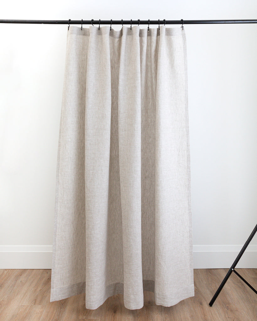 Natural linen shower curtain hanging in studio