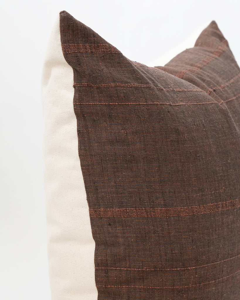 Detailed close up of brown toned striped cotton pillow.