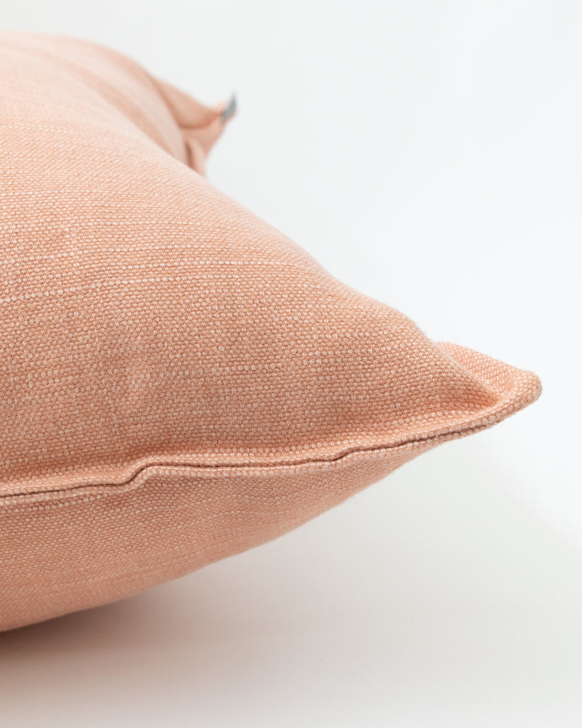 Detail close up of solid pink linen pillow.