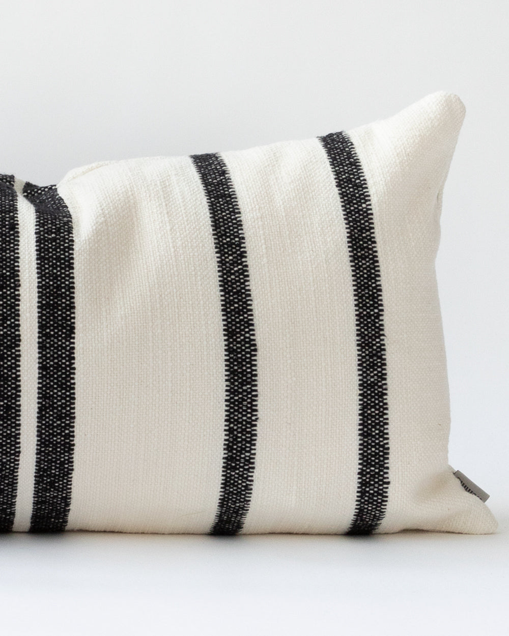 Detail close up of Black and cream striped lumbar pillow