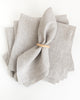 Natural beige linen napkin in wood napkin ring holder on stalk of napkins