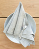 Natural beige linen napkin with plate and cutlery