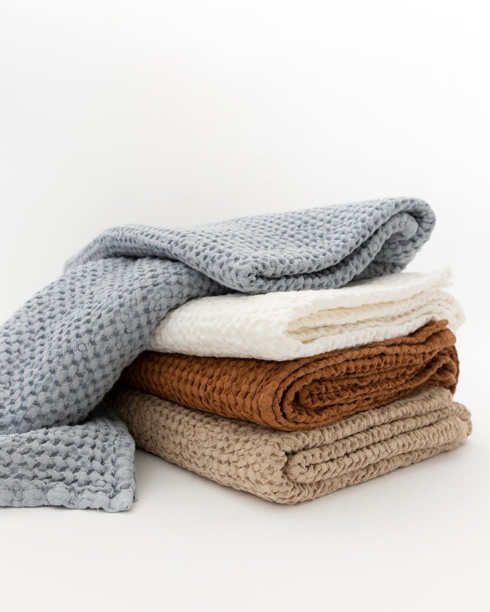 Pile of different colour linen-cotton waffle bath towels.