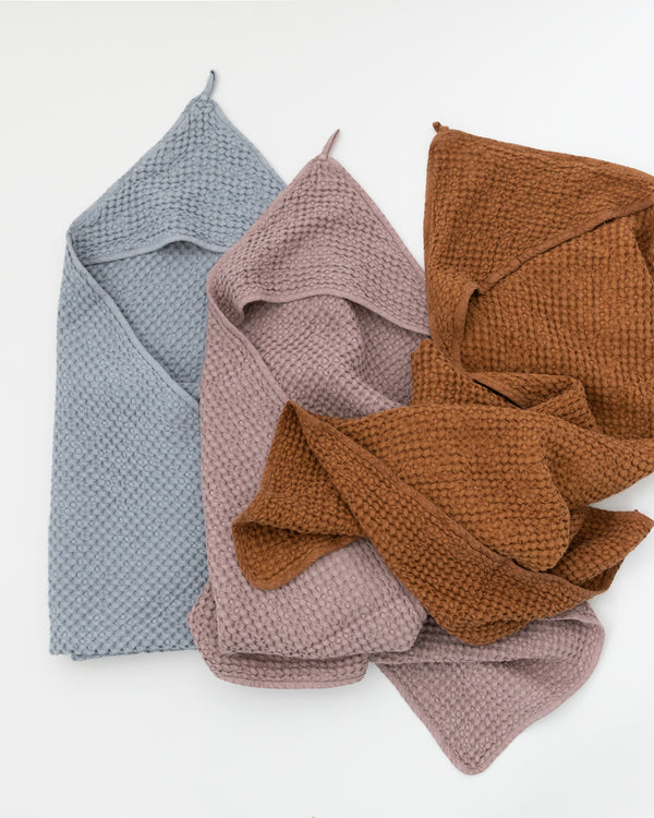 Three Hooded Waffle Towels in colours cinnamon, blue grey and woodrose.