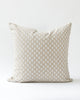 Square ikat inspired dot pillow in a creamy white on a natural beige background