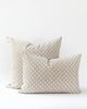ikat inspired dot pillow in a creamy white on a natural beige background