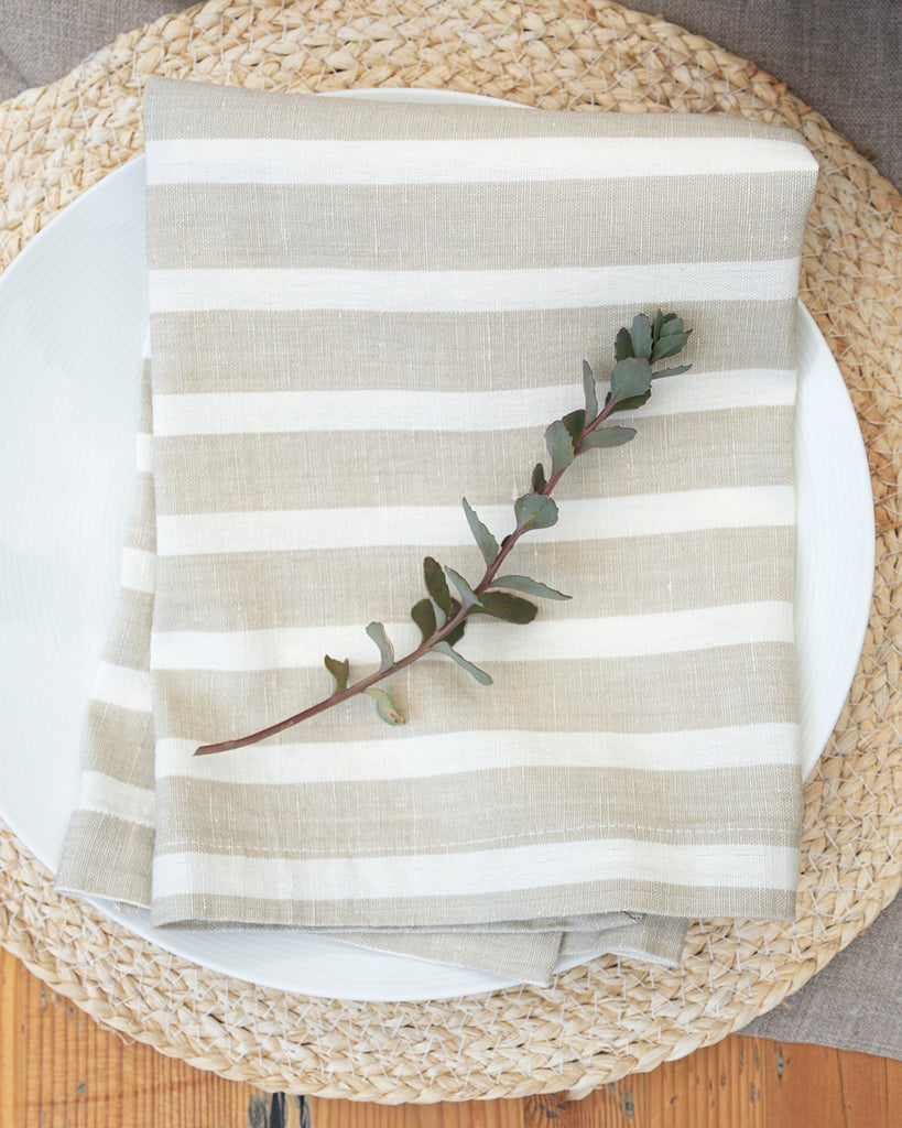 Marisol beige striped napkins sitting on table setting