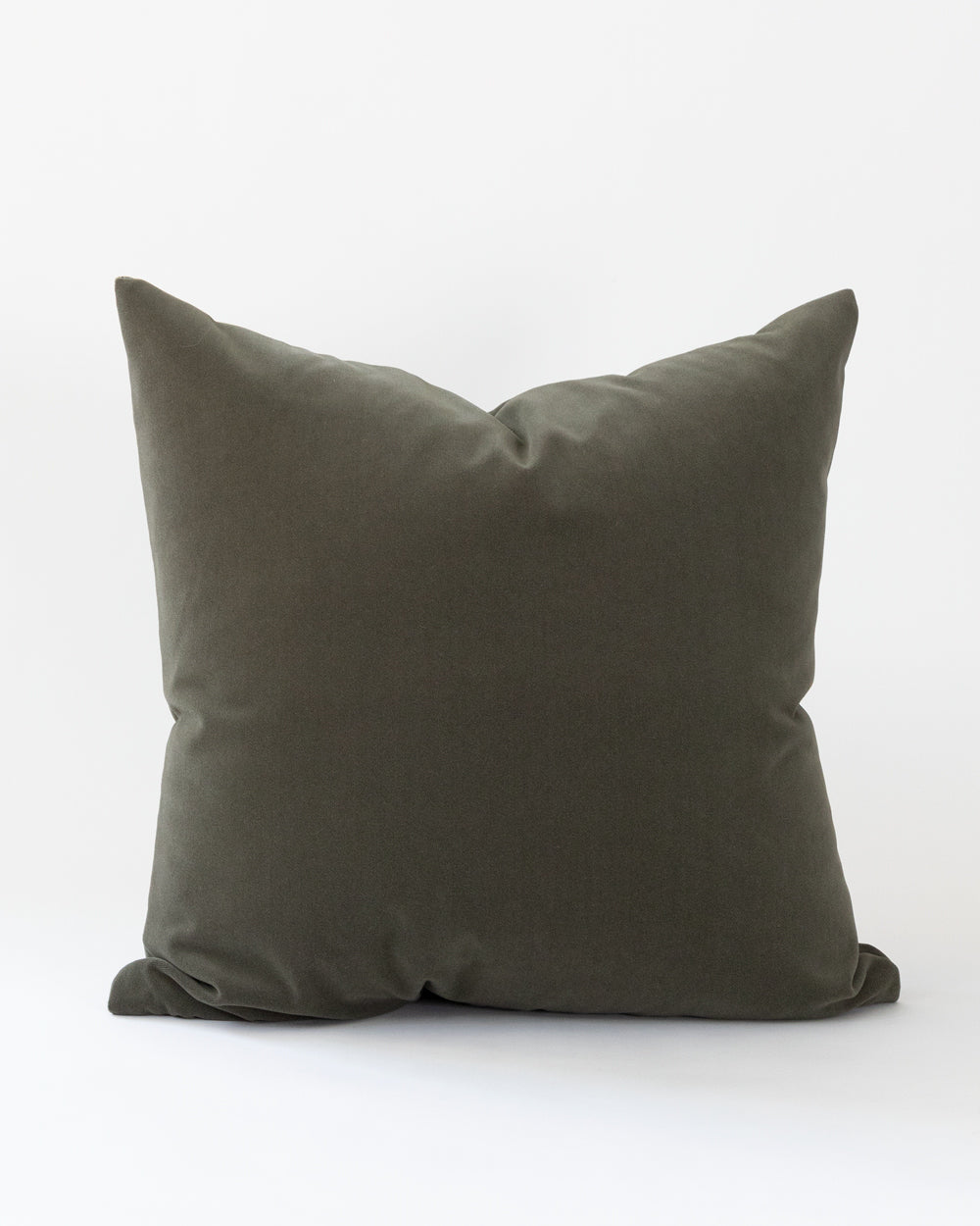 Dark forest green velvet pillow has a matte look rather than shiny