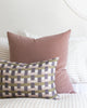 Rose velvet pillow paired with complimentary pillows
