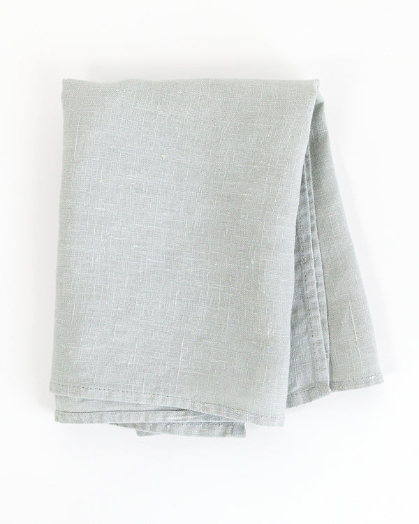 Folded blue stonewashed linen tea towel 