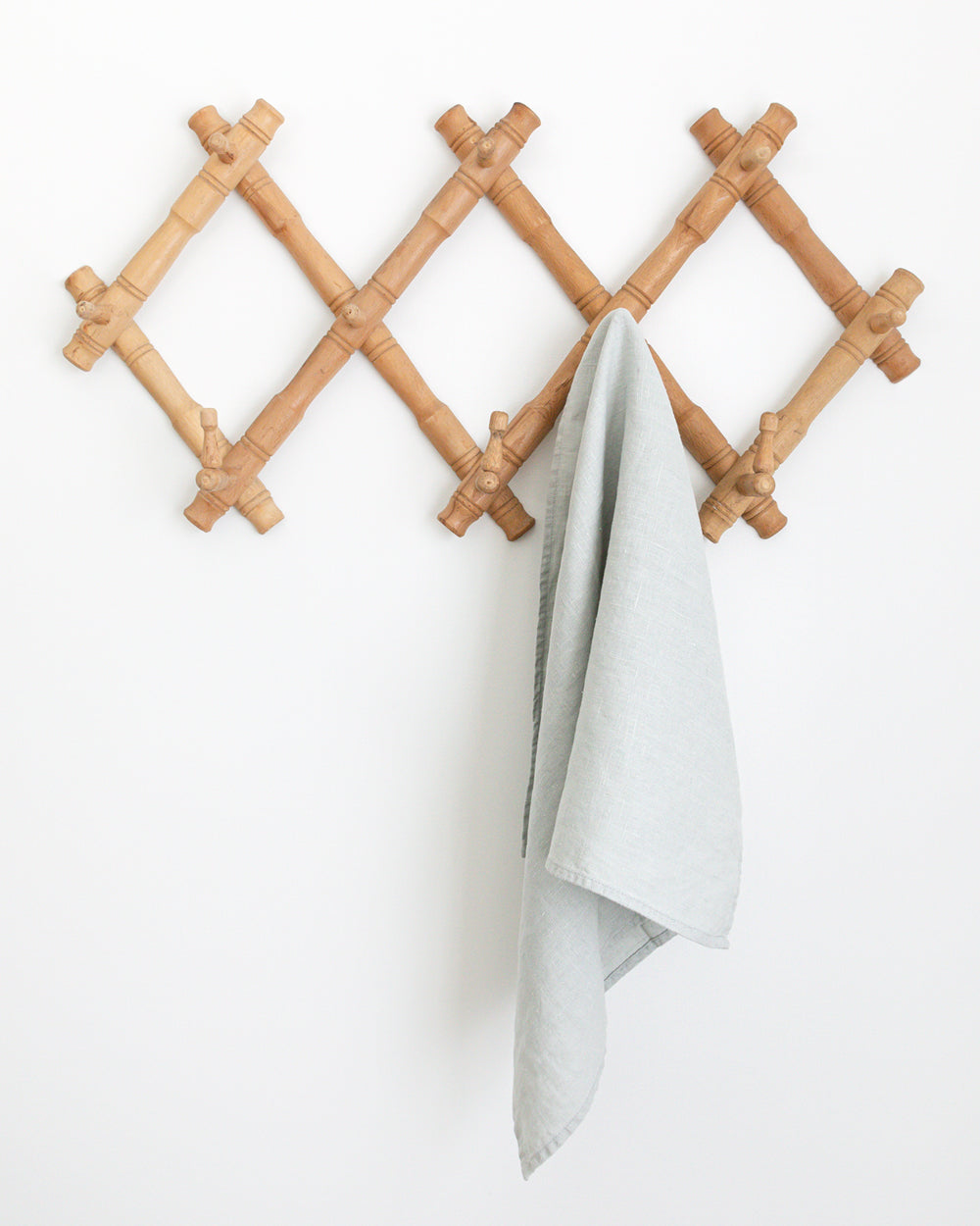 Blue stonewashed linen tea towel hanging on wall hook