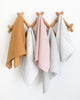 Linen tea towels from Hemme linen tea towel collection hanging on wall hooks
