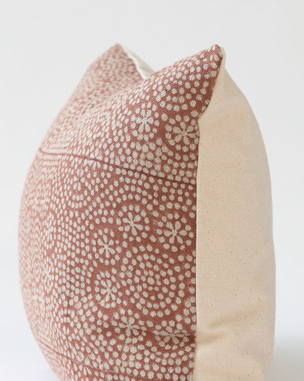 Close up detail of hand-blocked rust dot linen pillow