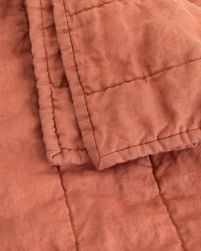 Close up detail of warm rust colour handmade Linen Quilt 