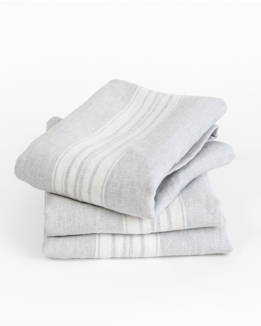 Stack of stone-washed linen tea towels is a soft, pale grey with a white stripe 