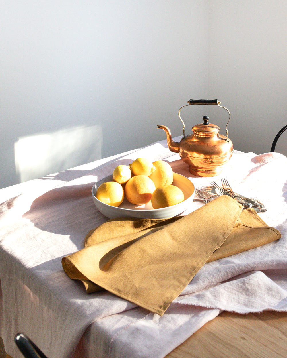  linen tea towel in brown earth-tone on table setting
