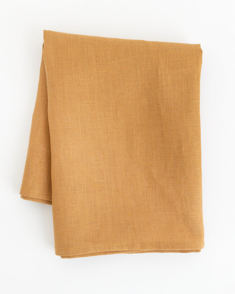 Folded  linen tea towel in brown earth-tone
