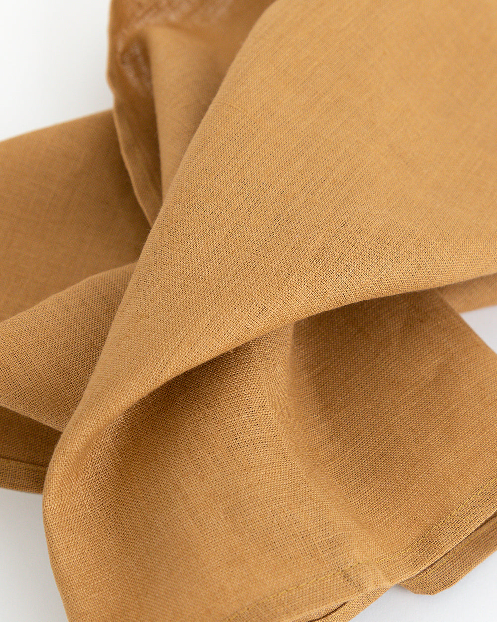 Close up detail of linen tea towel in brown earth-tone