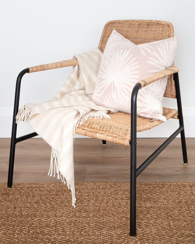 Alpaca wool beige and cream throw with tassels on rattan chair with complimentary pillow