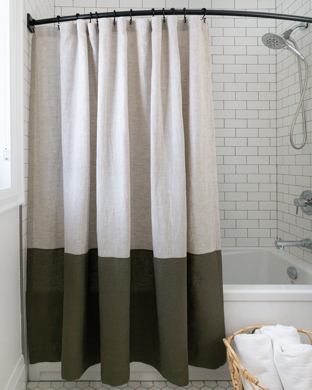 Spencer colour-blocked linen shower curtain hanging in white subway tile shower