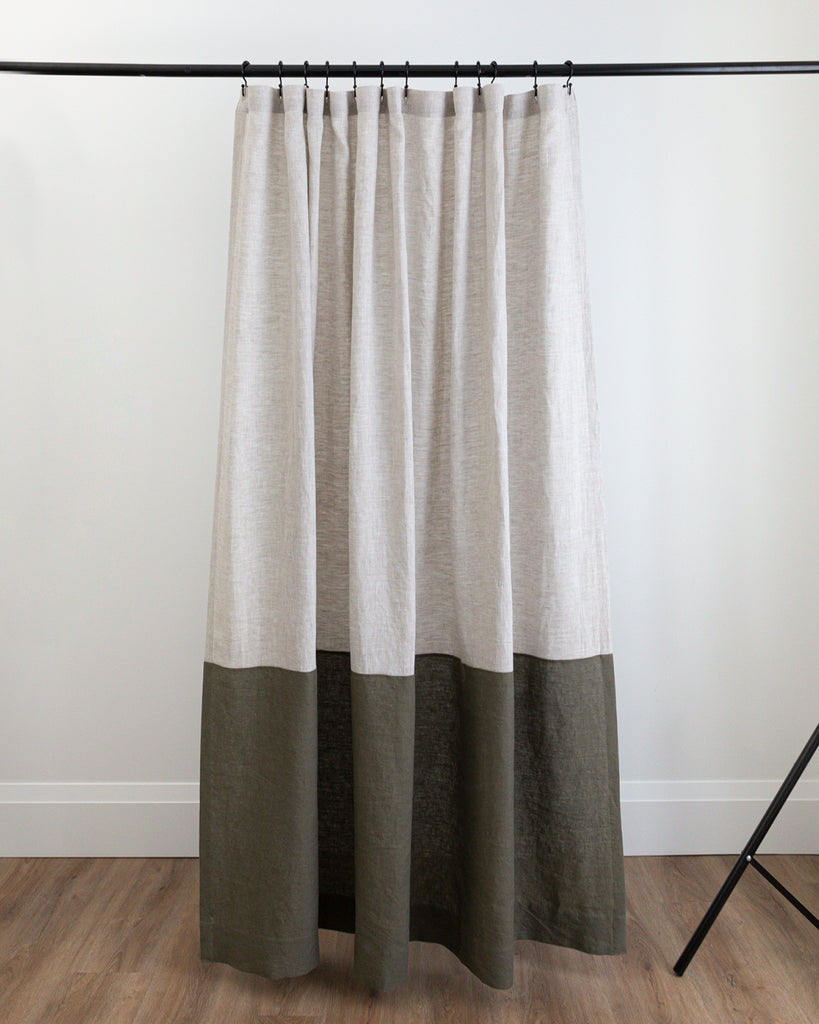 Spencer colour-blocked linen shower curtain hanging on black rod in studio setting