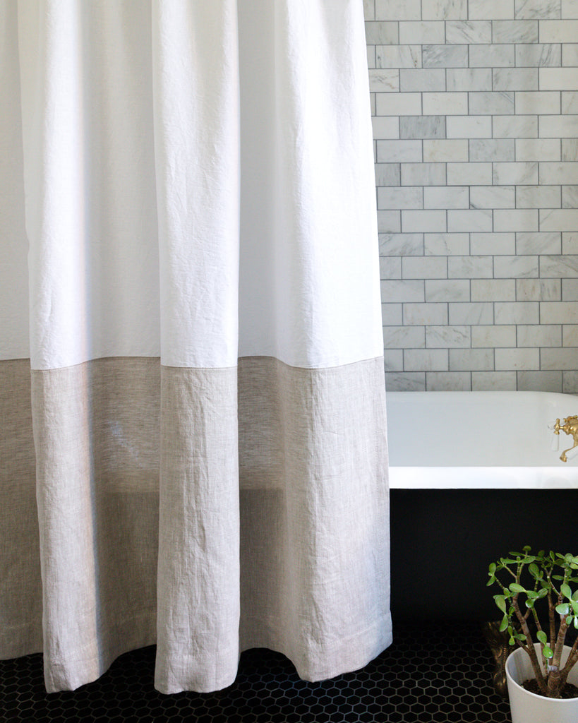 Close up detail of white and natural colour-blocked linen shower curtain
