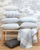 Collection of Hemme grey pillows on wood bench