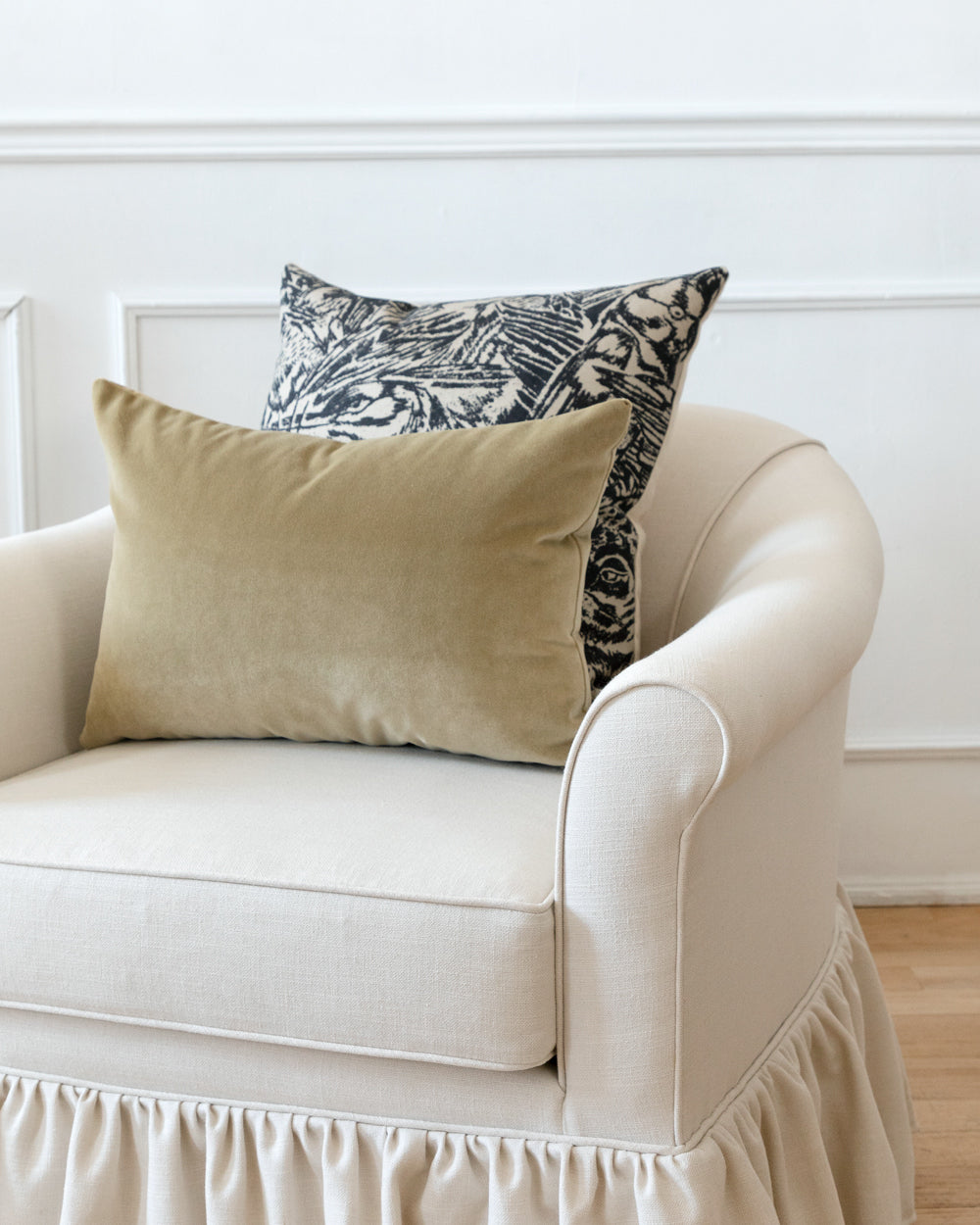 khaki beige velvet pillow on white sofa with abstract complimentary Hemme pillow 