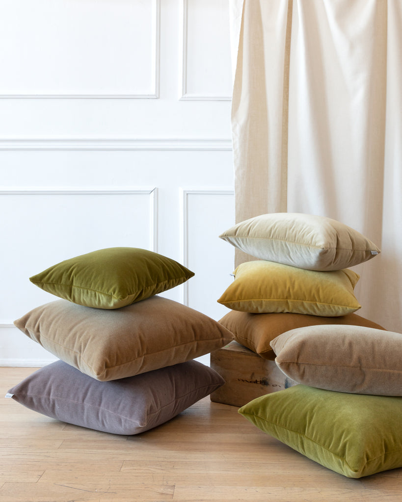 Collection of all Hemme velvet pillows in stacks