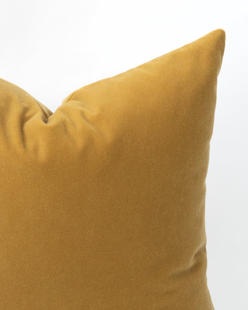Close up detail of ochre yellow velvet pillow